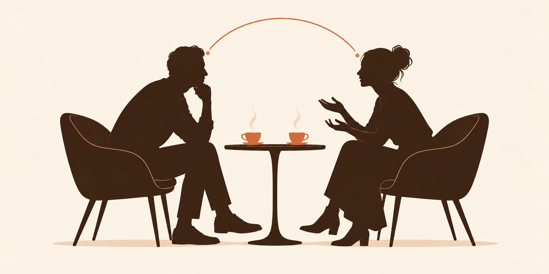 Coach and client in conversation across a table: the four coaching paradigms